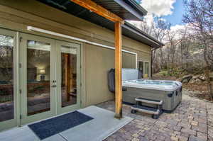 View of patio featuring french doors and a hot tub