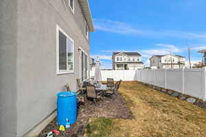 View of yard featuring a fenced backyard and outdoor dining space