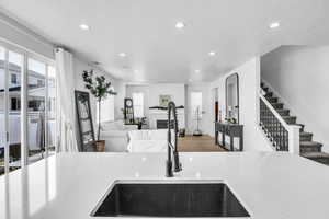 Kitchen with a healthy amount of sunlight, light countertops, a textured ceiling, and open floor plan