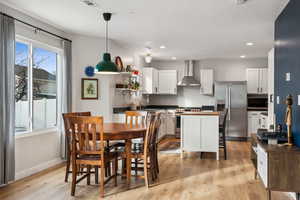 Dining space with baseboards, recessed lighting, visible vents, and light wood-style floors