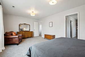 Bedroom featuring light colored carpet