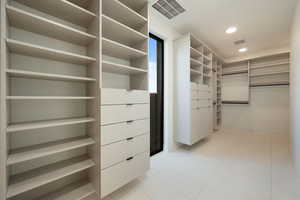 Spacious closet with visible vents and light tile patterned flooring