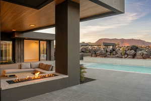 Pool featuring a fire pit, a patio area, and a mountain view