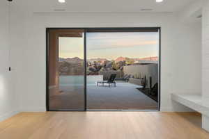 Doorway to outside featuring a mountain view, light wood-style flooring, recessed lighting, visible vents, and baseboards