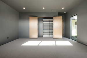 Unfurnished bedroom featuring light carpet and recessed lighting