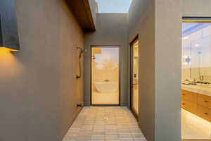 Hall with light tile patterned floors