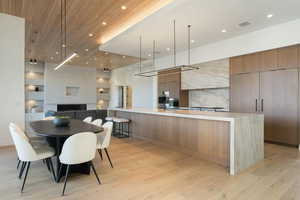 Kitchen featuring open floor plan, light countertops, modern cabinets, and wood ceiling