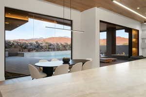 Dining space with a fireplace, a mountain view, and wood finished floors