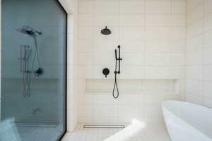 Bathroom with a freestanding bath and a shower stall