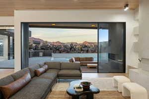 Living area with light wood finished floors and wooden ceiling