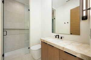 Bathroom featuring toilet, visible vents, vanity, a shower stall, and tile patterned floors