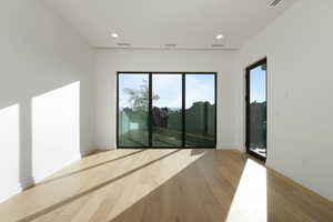 Spare room with light wood-style flooring, visible vents, and recessed lighting