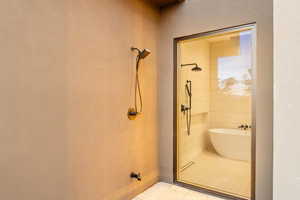 Bathroom with a stall shower and a soaking tub