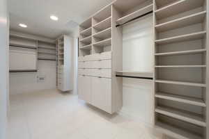 Walk in closet with visible vents and light tile patterned floors