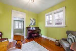 Sitting room featuring light wood-type flooring and baseboards