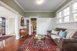 Living area featuring ornamental molding and wood finished floors