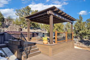 Wooden terrace with a jacuzzi and a pergola