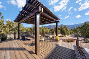 Wooden deck with a mountain view and a pergola