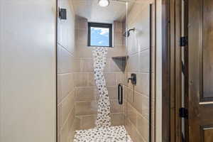 Full bath with a stall shower and a textured ceiling