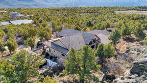 Aerial view featuring a wooded view