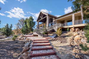 View of front of property featuring stairs and stucco siding