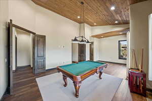 Rec room featuring dark wood-style floors, wooden ceiling, baseboards, and recessed lighting