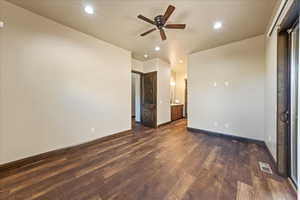 Unfurnished bedroom featuring baseboards, visible vents, dark wood-style flooring, ensuite bathroom, and recessed lighting