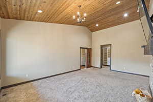 Empty room with recessed lighting, wood ceiling, carpet, and baseboards