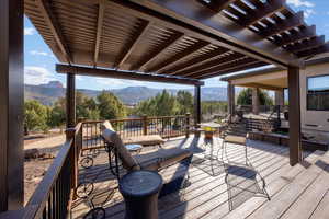 Wooden terrace featuring a mountain view and a pergola