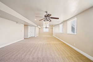 Empty room featuring light carpet, baseboards, a textured ceiling, and recessed lighting