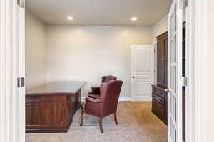 Office area with baseboards, recessed lighting, and light colored carpet