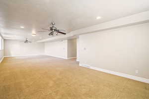 Carpeted spare room with a textured ceiling, recessed lighting, a ceiling fan, visible vents, and baseboards