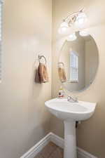 Bathroom featuring baseboards and tile patterned floors