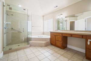 Full bath featuring visible vents, tile patterned flooring, vaulted ceiling, a shower stall, and a bath