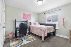 Carpeted bedroom featuring baseboards