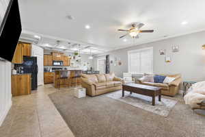 Living room featuring beam ceiling, light tile patterned floors, recessed lighting, ceiling fan, and coffered ceiling