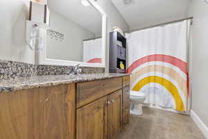 Full bathroom featuring visible vents, vanity, toilet, and tile patterned floors