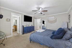 Bedroom featuring light carpet, visible vents, and crown molding