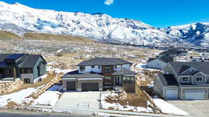 View of front of house featuring a garage, concrete driveway, and a mountain view