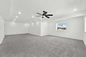 Carpeted empty room with a ceiling fan, recessed lighting, and baseboards