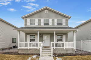 View of front of home featuring a porch, fence, and central AC unit