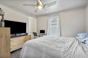 Bedroom featuring visible vents, ceiling fan, and a textured ceiling