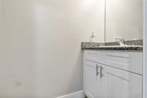 Bathroom with vanity and baseboards