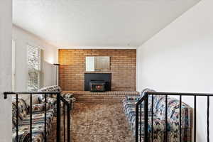 Carpeted living area with a textured ceiling