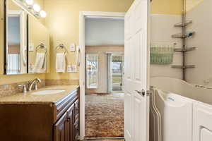 Full bath with a tub to relax in and vanity