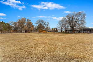 View of yard with an outbuilding and fence