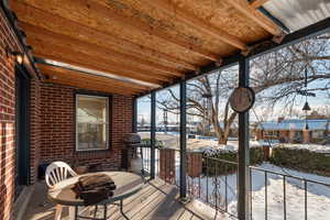 Snow covered deck with a grill