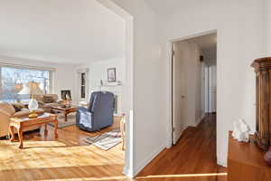 Living room featuring hardwood / wood-style flooring and crown molding