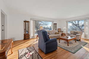 Living room with crown molding and hardwood / wood-style floors