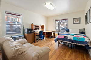 Bedroom with hardwood / wood-style flooring